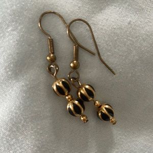 Gold and black ball dangly earrings